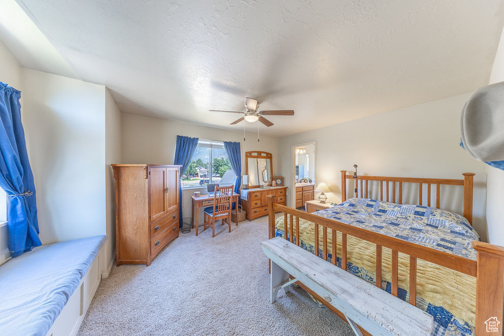 Bedroom with light colored carpet and ceiling fan