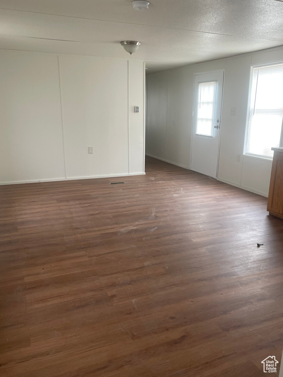 Unfurnished room featuring dark wood-style flooring