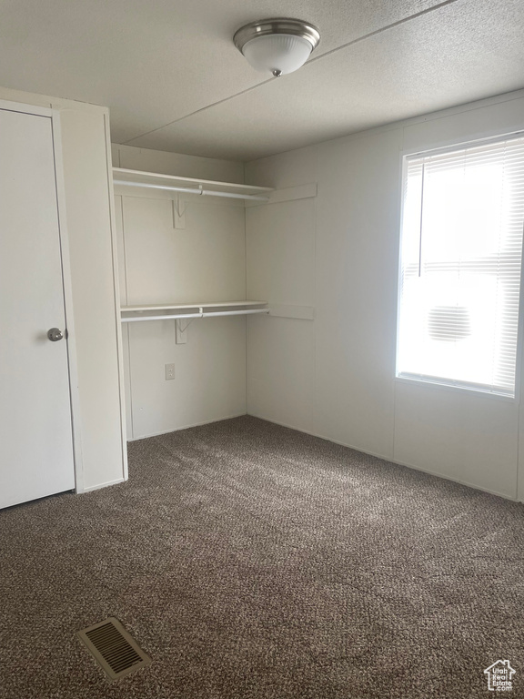 Unfurnished bedroom with carpet floors and a closet