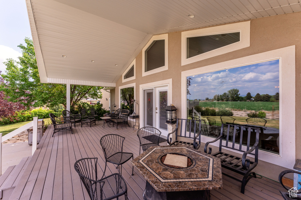 Wooden deck with a fire pit and outdoor dining area