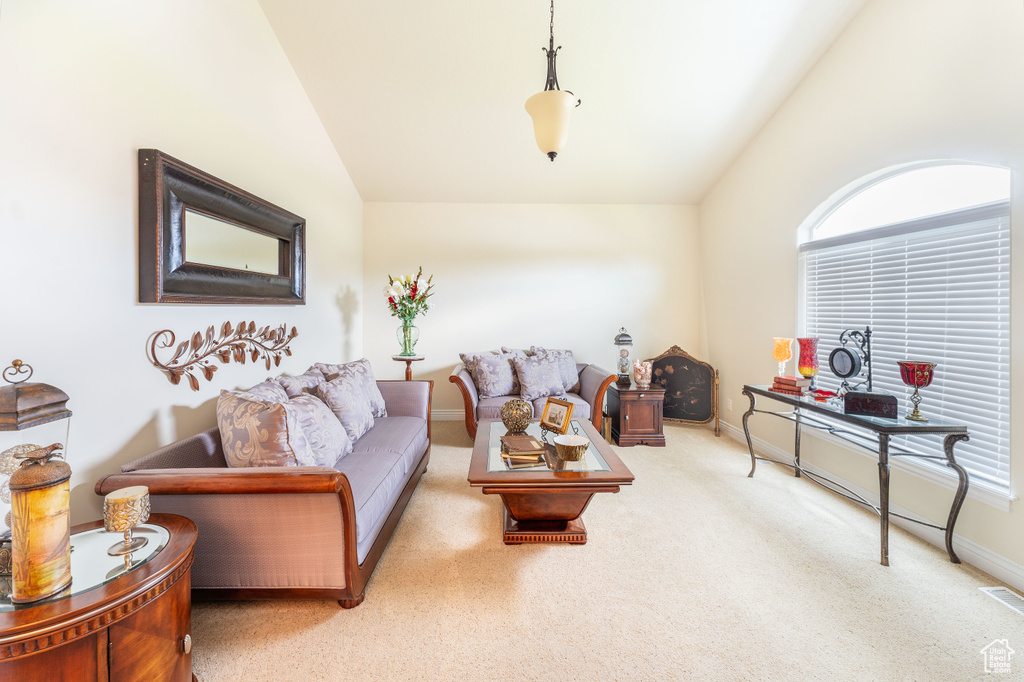 Living area featuring lofted ceiling and carpet