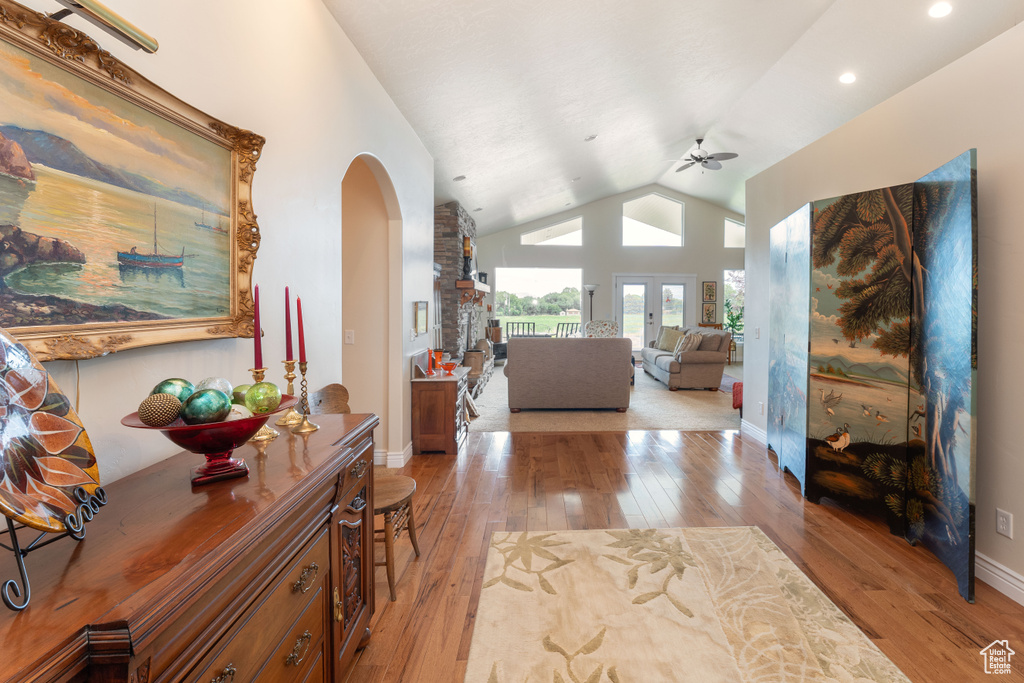 Entrance foyer featuring a ceiling fan, light wood-style flooring, arched walkways, lofted ceiling, and recessed lighting