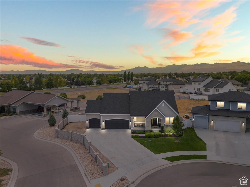 View of front of property featuring driveway, a mountain view, and a residential view