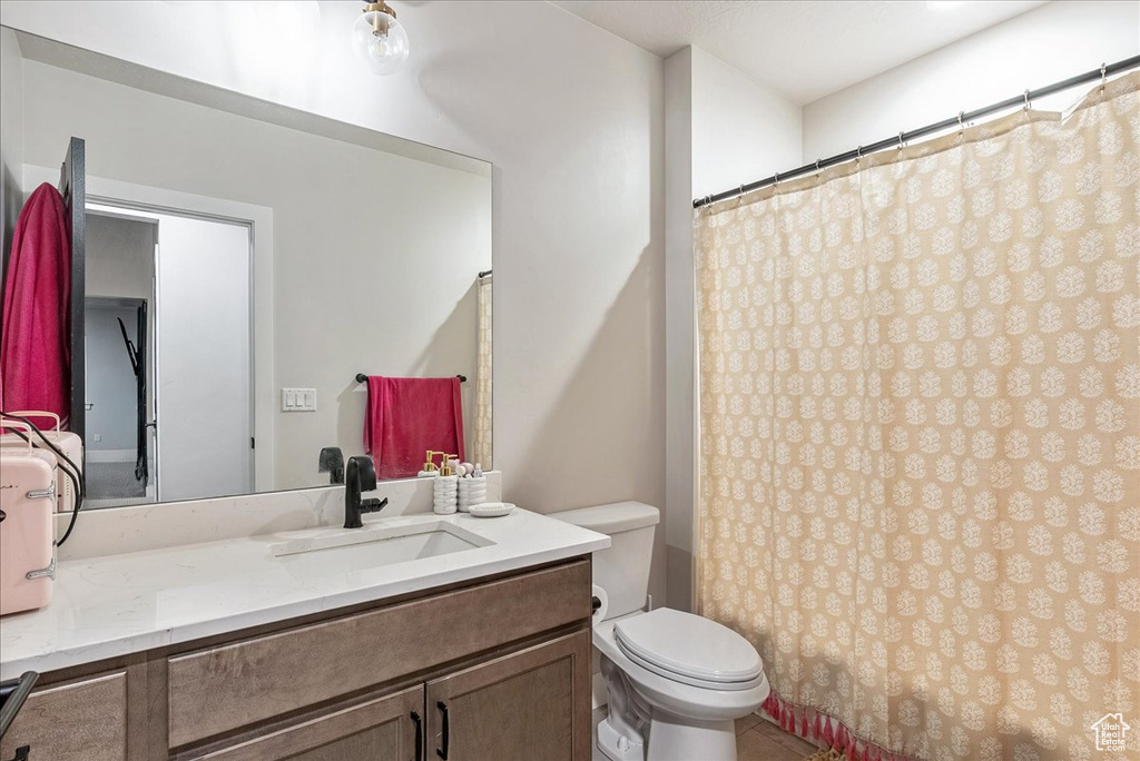 Bathroom featuring vanity and curtained shower