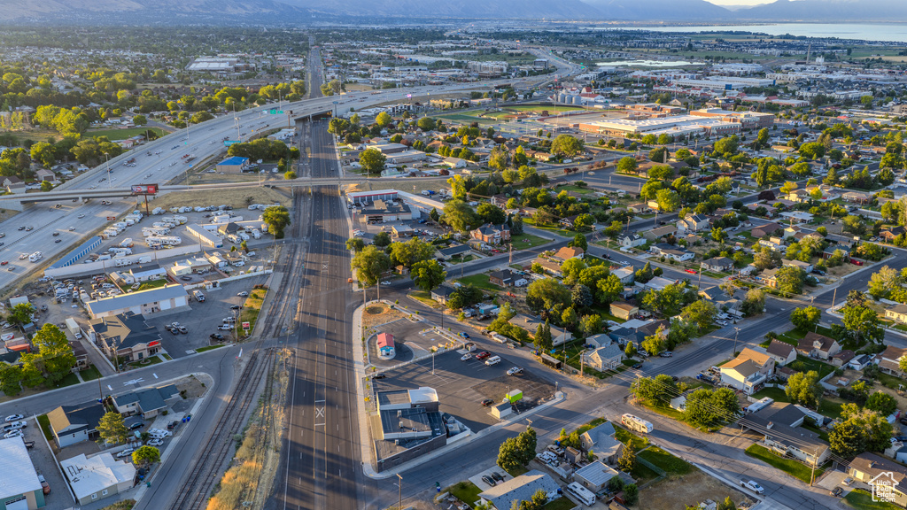 Aerial view of property and surrounding area featuring a mountainous background and a highway