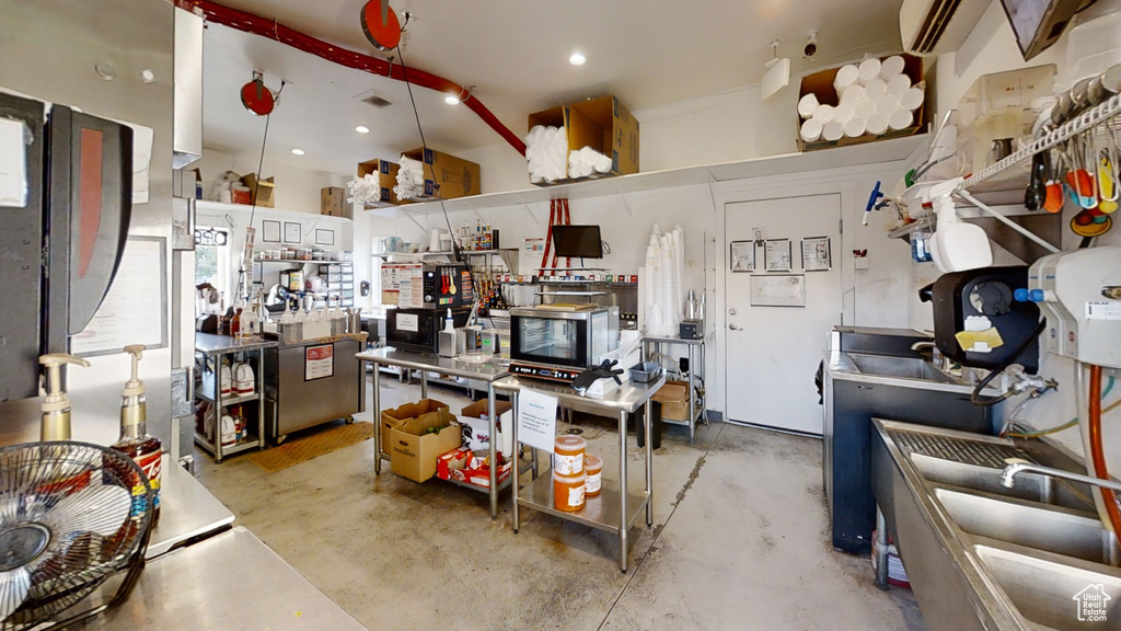 Kitchen with concrete floors and recessed lighting