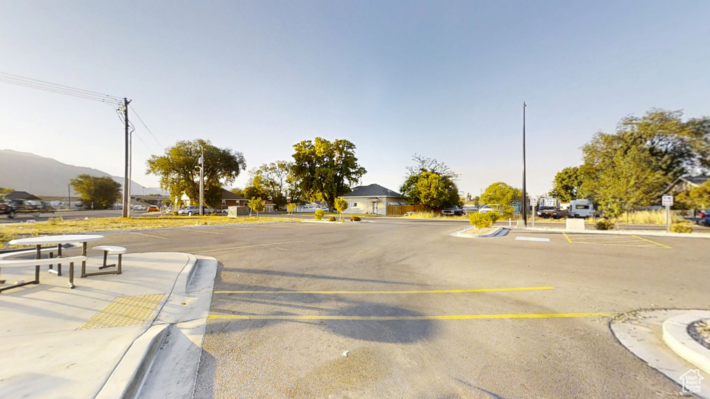 View of asphalt road featuring curbs