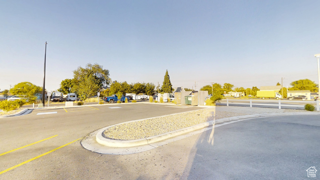 View of asphalt road featuring curbs and a residential view