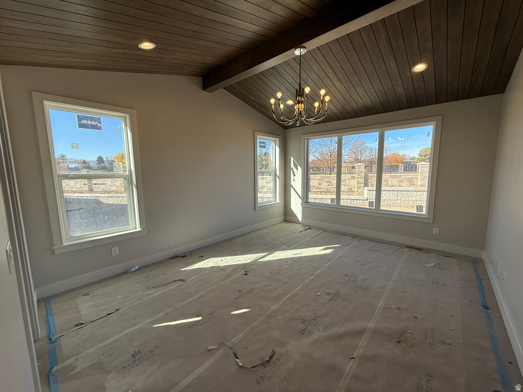 Unfurnished dining area featuring a chandelier, recessed lighting, and wood ceiling