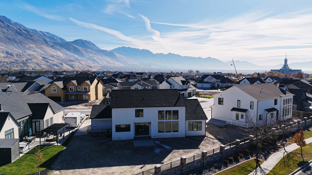Aerial view of residential area featuring a mountainous background