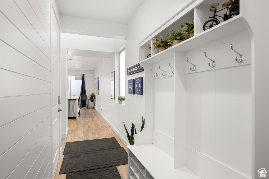 Mudroom featuring light wood-style floors and baseboards