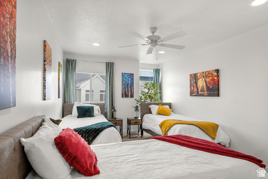 Bedroom featuring a textured ceiling, recessed lighting, and a ceiling fan