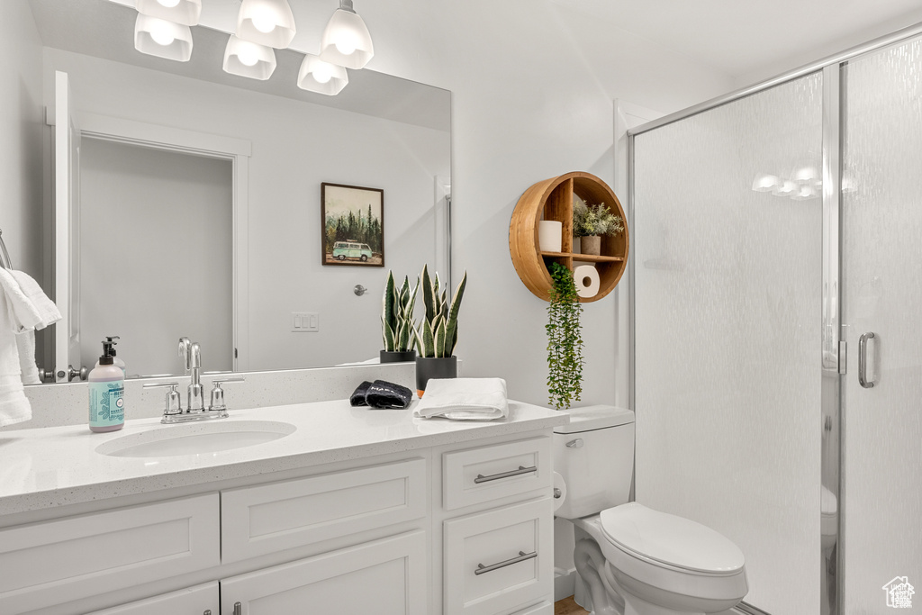 Bathroom featuring a stall shower and vanity
