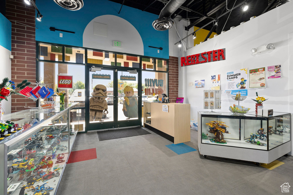 Reception area featuring a towering ceiling and french doors