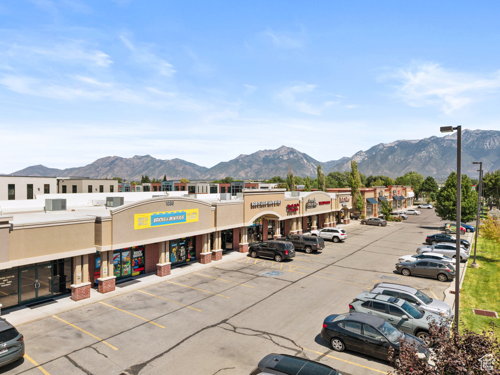 View of commercial location with a mountain view and uncovered parking