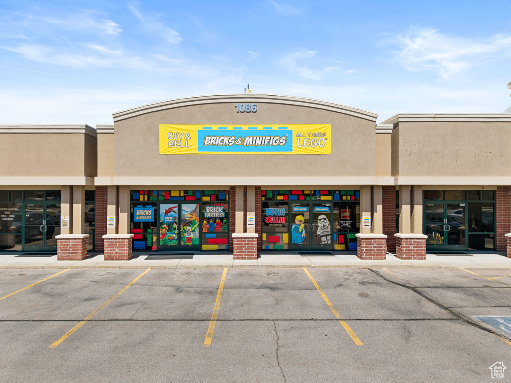 View of building exterior featuring uncovered parking