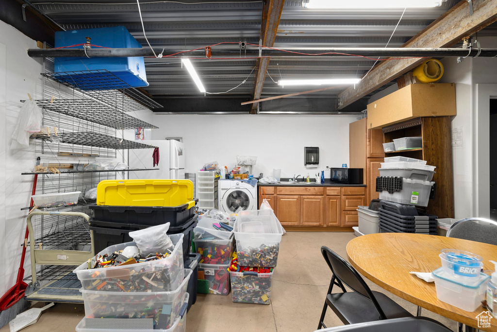 Misc room with finished concrete floors and washer / dryer
