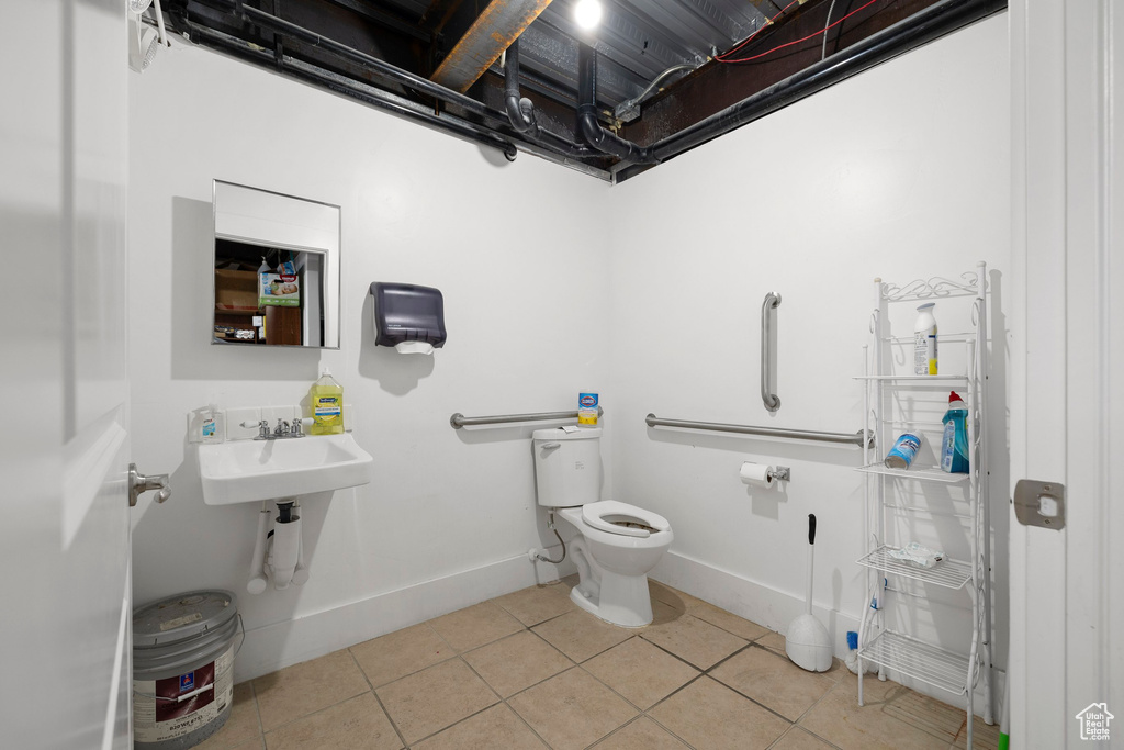Half bathroom featuring baseboards and light tile patterned floors