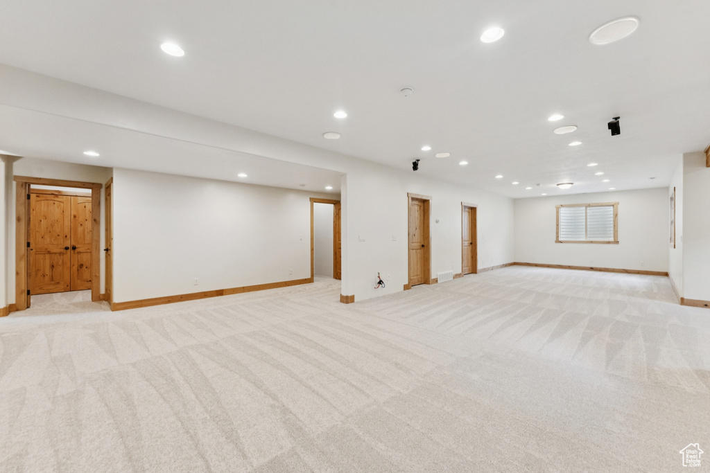 Finished basement featuring light carpet and recessed lighting