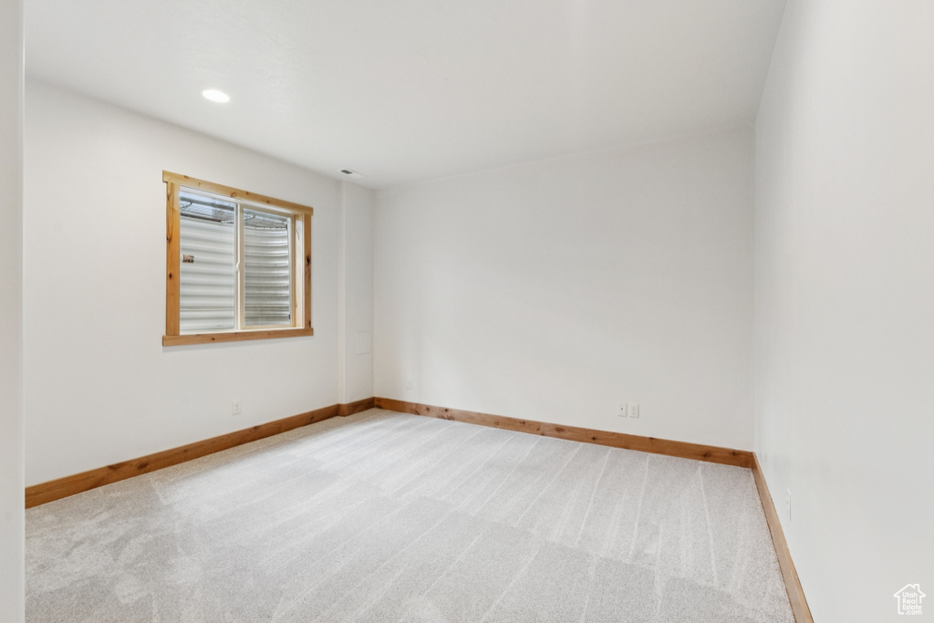 Spare room with light colored carpet and recessed lighting