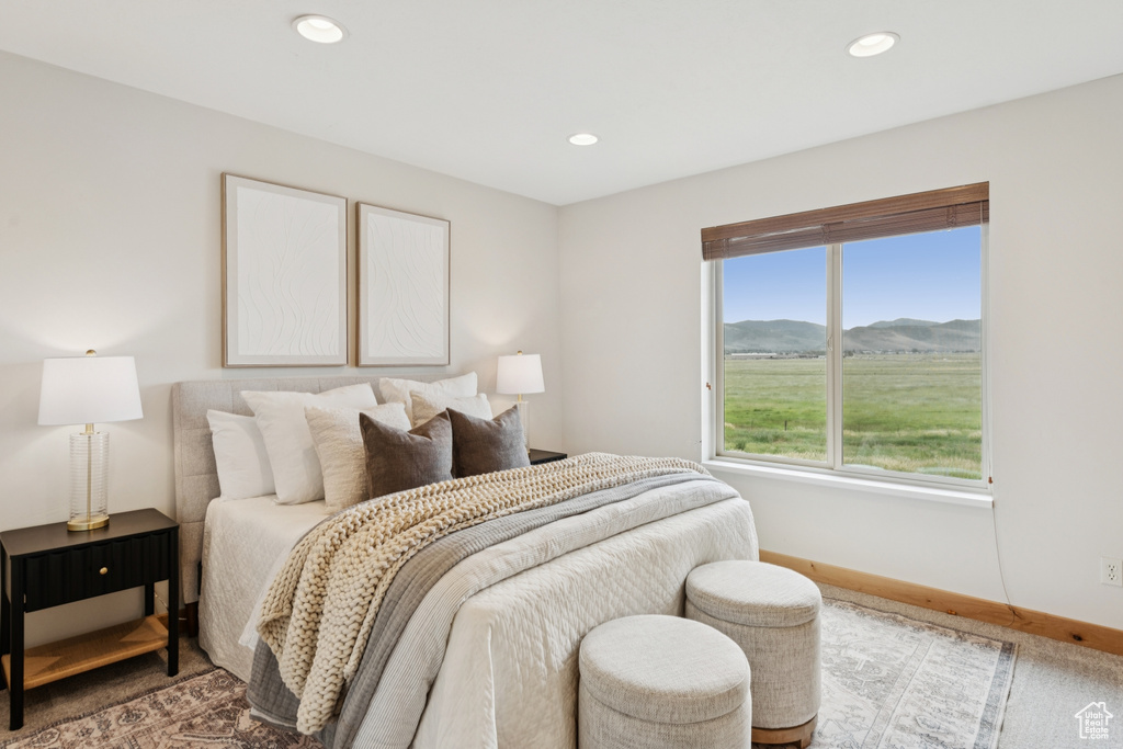 Bedroom with recessed lighting, a mountain view, and carpet flooring