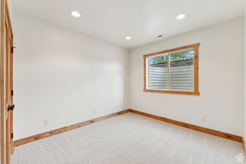 Empty room with recessed lighting and carpet floors