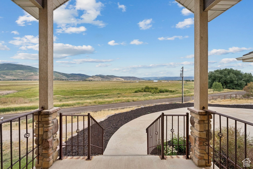 View of patio / terrace with a rural view and a mountain view