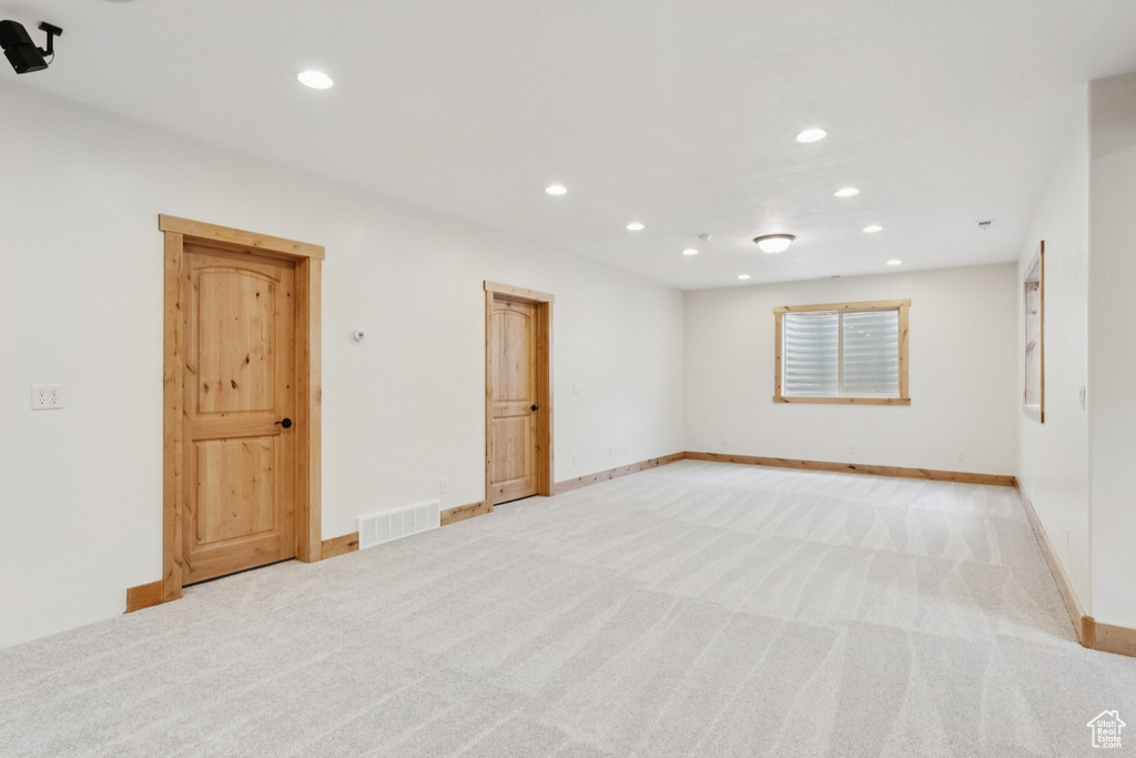 Empty room featuring light carpet and recessed lighting
