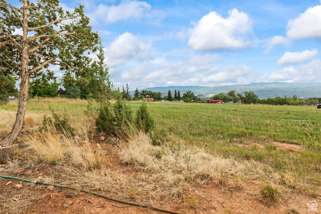 View of undeveloped land featuring rural landscape and a mountainous background