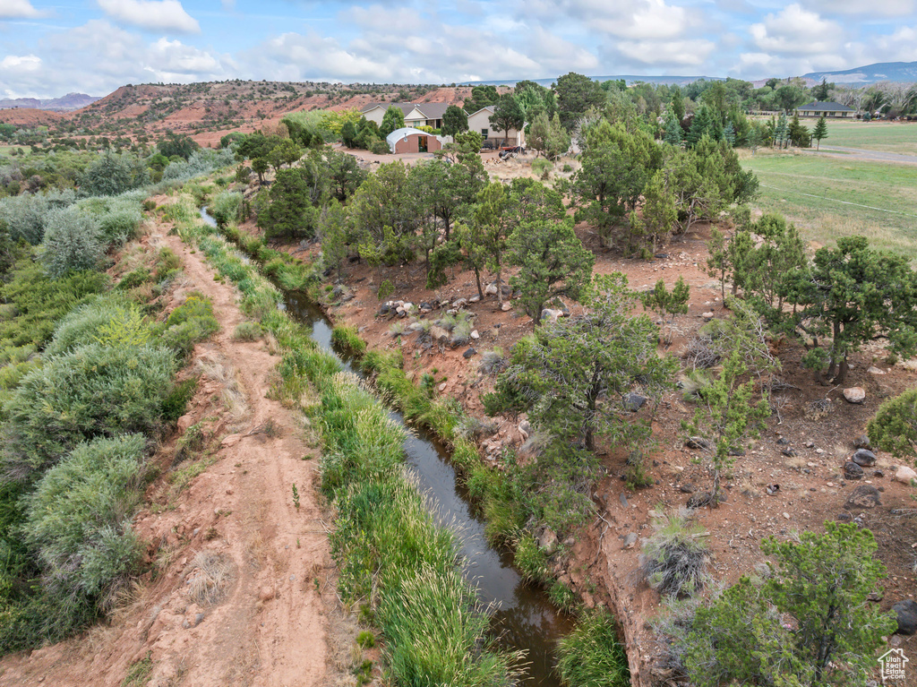 Aerial view of property and surrounding area with a mountainous background and rural landscape