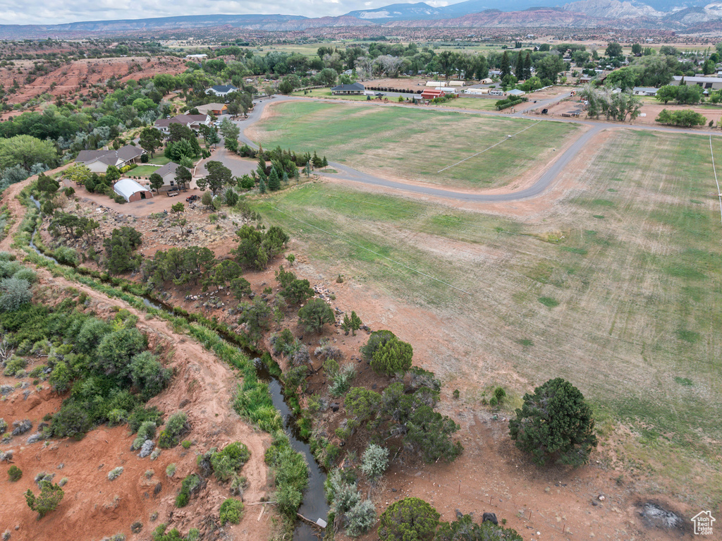 Aerial overview of property\'s location featuring rural landscape and mountains