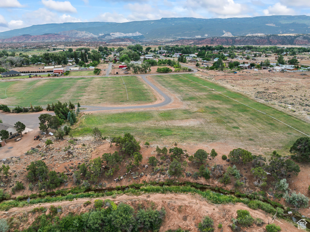 Aerial view of property\'s location with a mountainous background and rural landscape