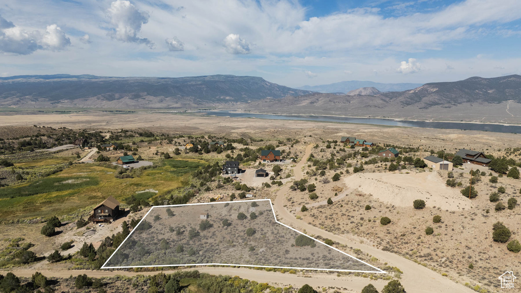 Aerial view of property\'s location with property boundaries highlighted and a water and mountain view