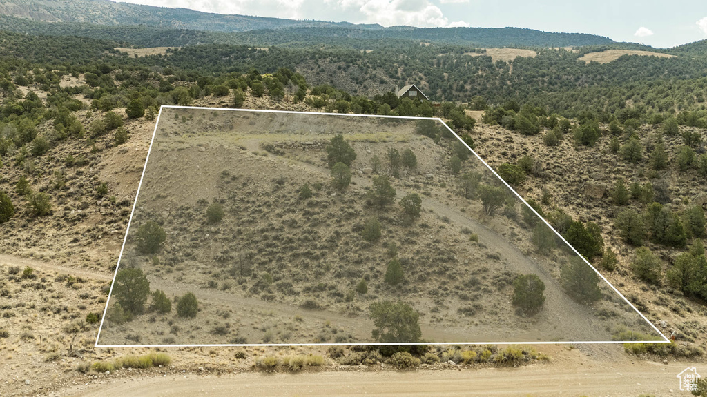 Overview of rural landscape with property parcel outlined and mountains