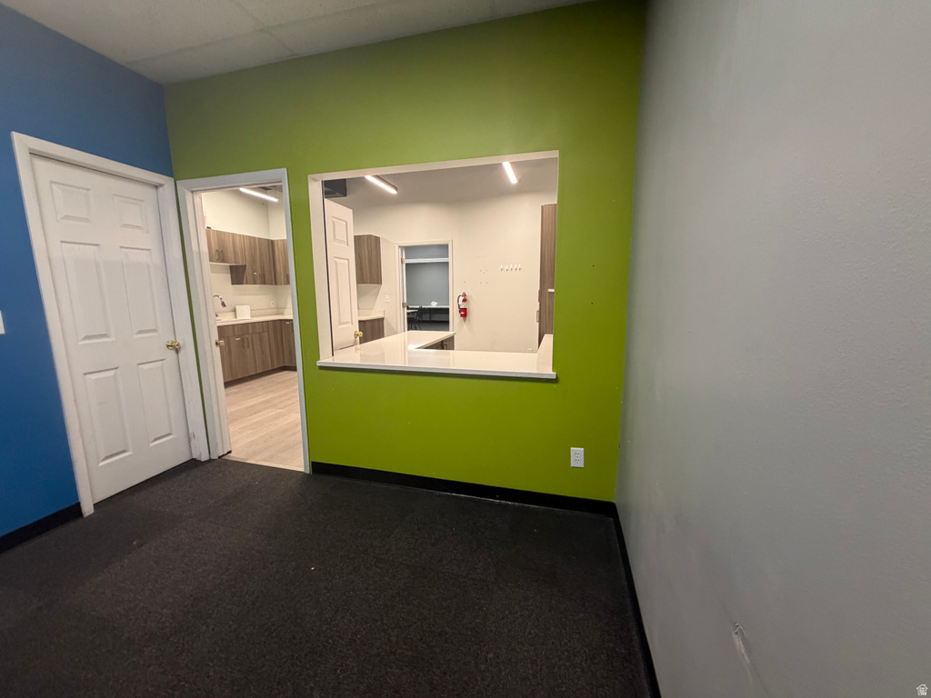 Flexible open area featuring a pass-through window with a white countertop