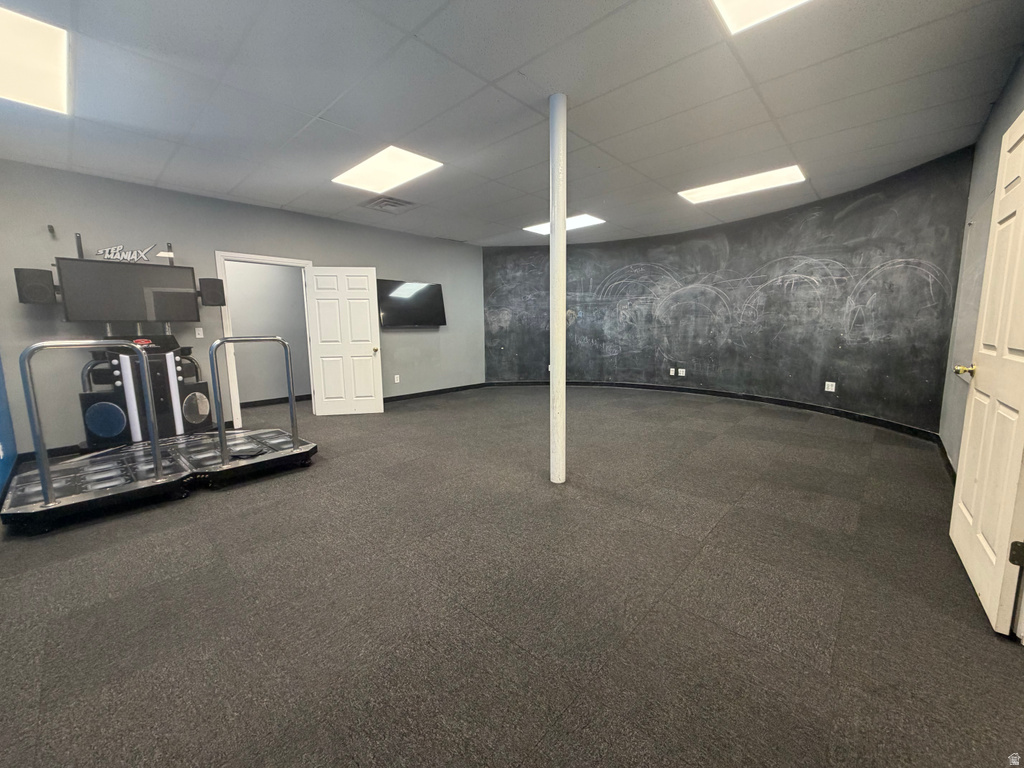 Spacious interior room featuring dark gray carpeting and light gray walls