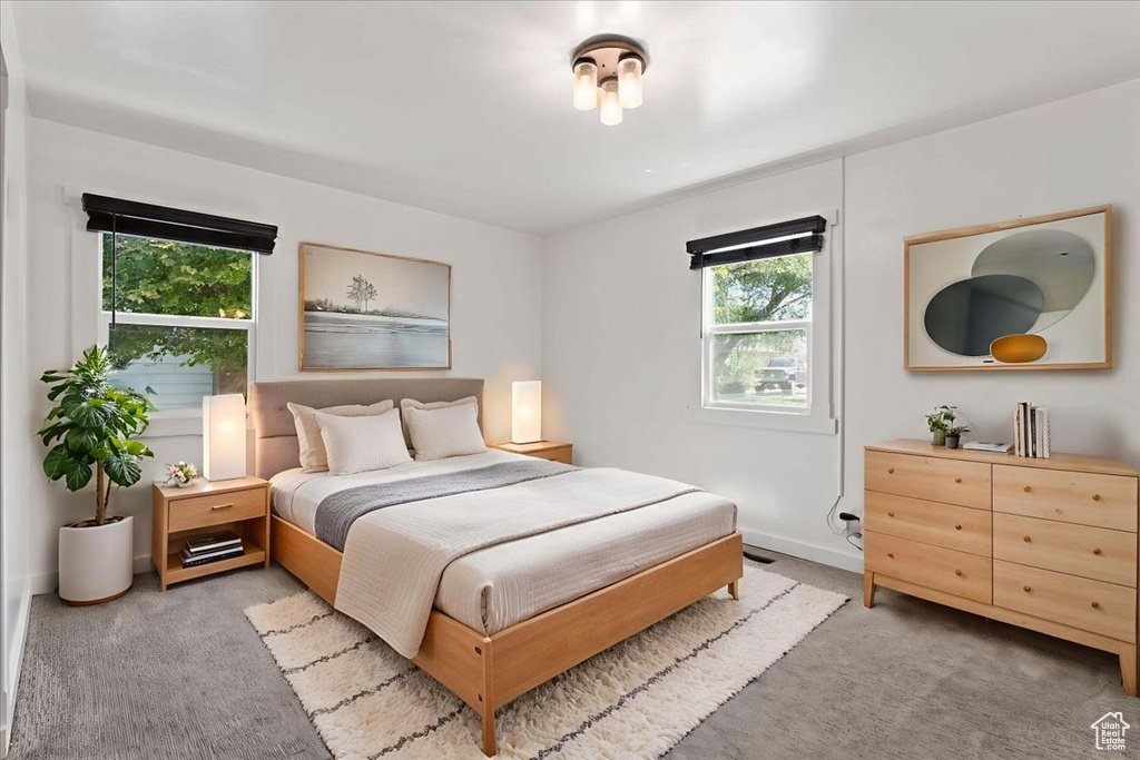 Bedroom featuring carpet flooring and baseboards