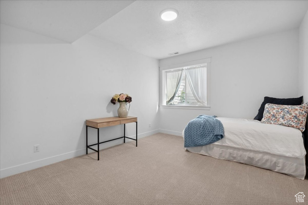 Carpeted bedroom with baseboards
