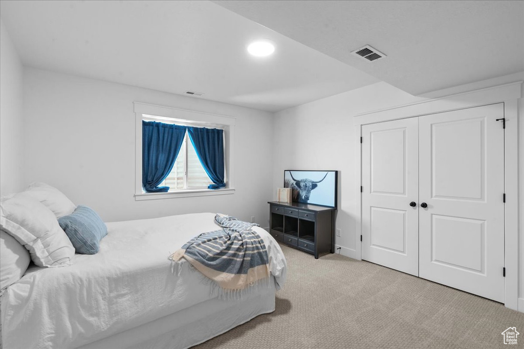 Carpeted bedroom featuring a closet and recessed lighting