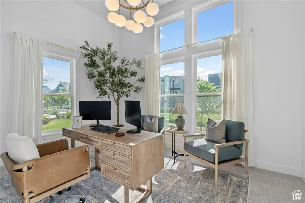 Office area with light carpet and a chandelier