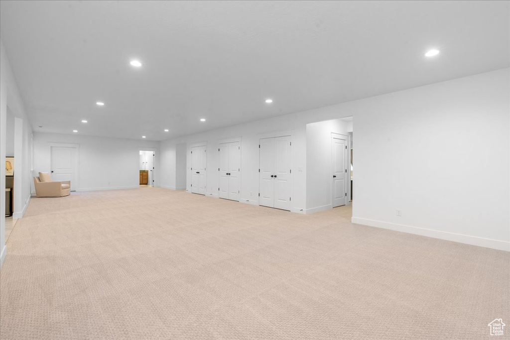 Basement featuring recessed lighting and light carpet