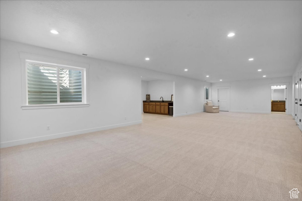 Basement with recessed lighting and light carpet