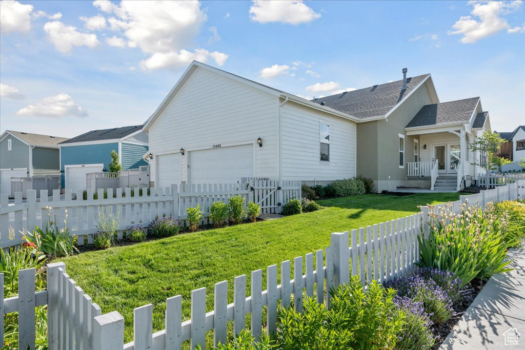 View of property exterior featuring covered porch, a shingled roof, a residential view, and an attached garage