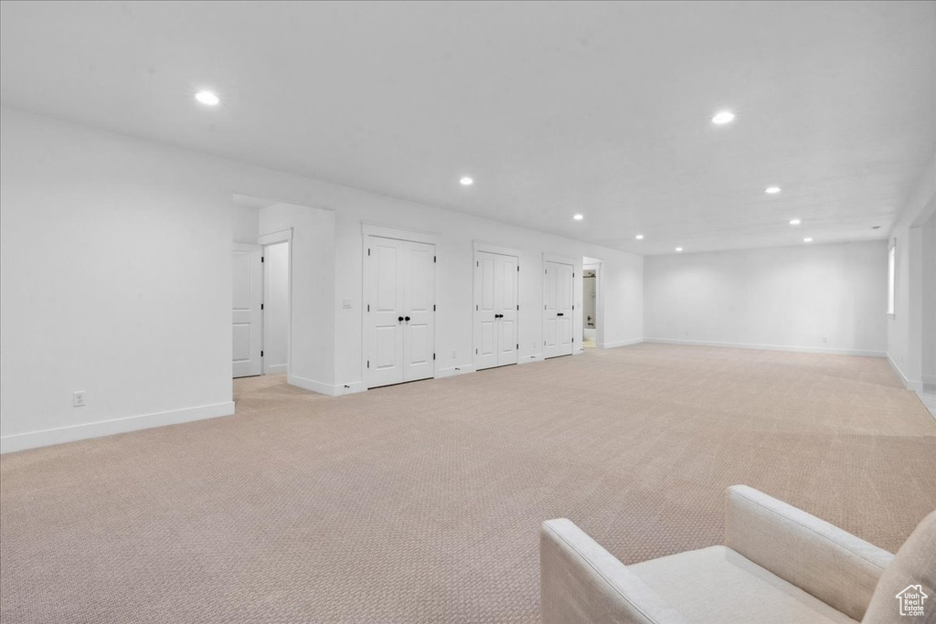 Basement with recessed lighting and light colored carpet