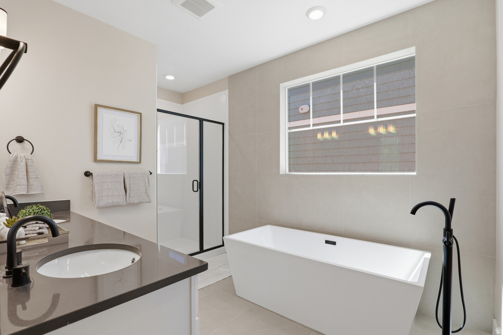 Contemporary bathroom featuring a freestanding soaking tub with a floor-mounted matte black faucet