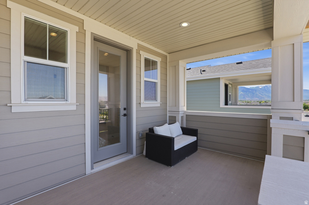 Covered porch with recessed lighting, composite flooring, and horizontal siding