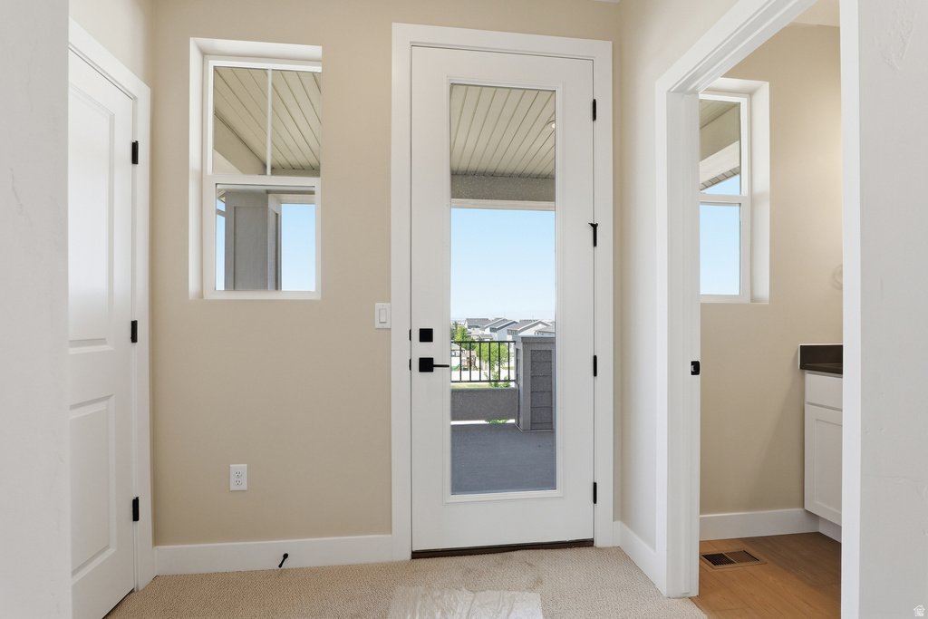 Full-light French door opening to a private balcony
