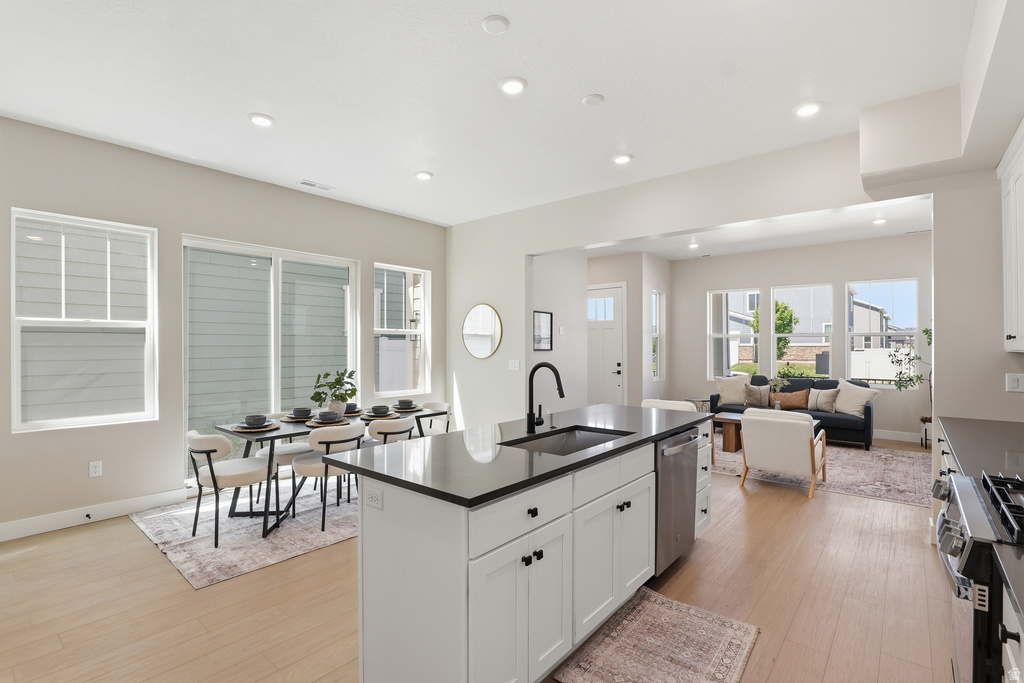 Open-concept living area featuring light wood-finish flooring throughout