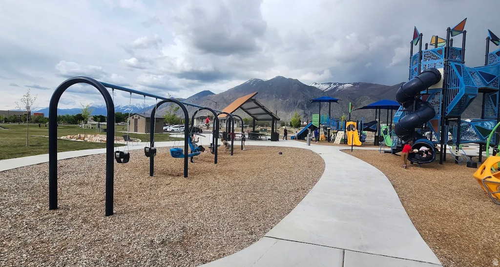 Expansive community park featuring a playground with swings, multiple slides, and climbing structures