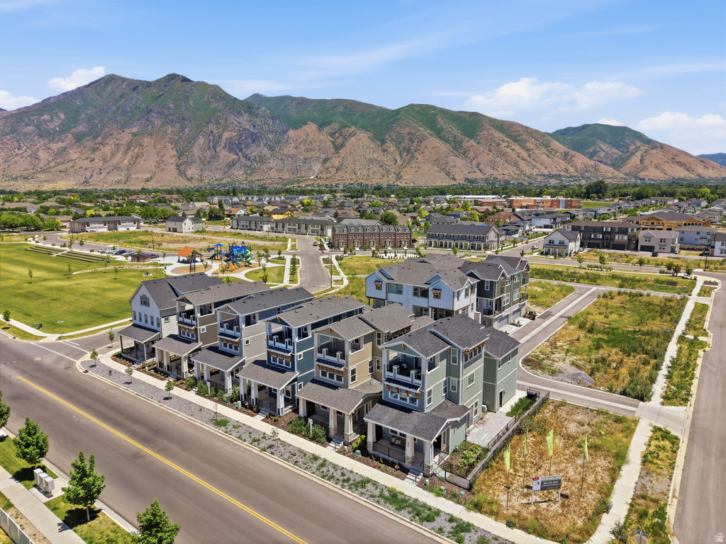 Modern townhome community featuring varied exterior siding colors, front porches, and private balconies